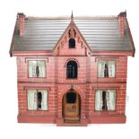 A good painted red brick wooden Victorian Dolls house in the Gothic style,