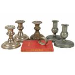 Three loaded silver piano candlesticks.