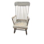A late Victorian beech and pine stick back rocking chair.