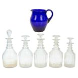 A blue glass water jug of bellied form.