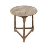 An elm and oak circular cricket table.