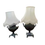 Two lamp bases with shades, each converted from a copper tea urn.