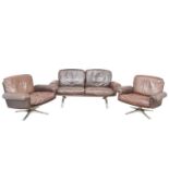 A brown leather De Sede DS-31 sofa and two swivel chairs.