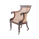 A Regency rosewood bergere library armchair.