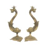 A pair of heavy brass table lamps cast as dolphins.