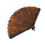 A Chinese Canton carved tortoiseshell brise fan.