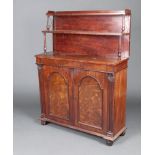 A Regency mahogany chiffonier with 2 raised shelves to the back above a secret drawer with