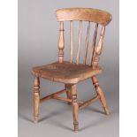 A child's 19th Century elm and beech stick and bar back Windsor chair with solid seat, raised on