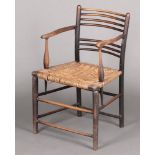A William Morris Sussex arm chair with woven cane seat Two metal brackets to the back of the arm,