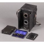 An early 20th century Ross Portable Dividing Twin Lens Camera together with three cased Primus