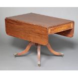 A 19th century mahogany pedestal Pembroke table fitted a drawer, raised on ring turned column and