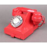 A 1940's red Bakelite GPO 300 series red dial telephone, the base fitted a tray