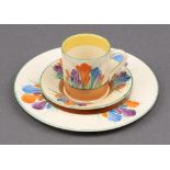 A Clarice Cliff Crocus pattern coffee cup and saucer (crack to the saucer) together with a