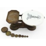 An early 20thC cast iron set of kitchen scales by Day & Millward with pictorial ceramic platform,