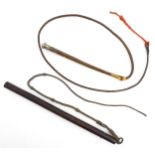 An early 20thC hunting whip, with weighted, plaited leather handle and thong terminating in a silver