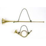 A late 20thC French hunting horn, together with a post horn. The largest approx 33" long (2)