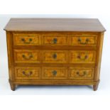 An 18thC German chest of drawers / commode with an oak top above three long drawers with ash