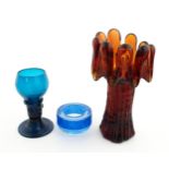 A Kosta Boda dark amber glass sunflower candle holder, together with a teal / blue glass roemer