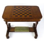 A 19thC oak games table with a sliding central section inlaid with a games board, the central