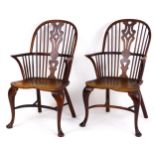 A pair of late 19thC double bow back yew wood Windsor chairs with tapering, pierced back splats,