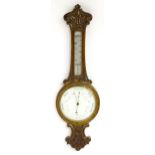A carved oak wheel barometer with thermometer, the dial signed E. H. Durran, Banbury. Approx. 32 1/