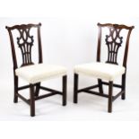 A pair of Georgian mahogany side chairs with carved, shaped cresting rails and Chippendale style