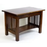 An Arts & Crafts oak side table with a planked top, peg jointed base and having slatted ends