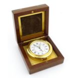 An Asprey travelling alarm clock with quartz movement and fitted case. Case approx. 2 1/2" wide
