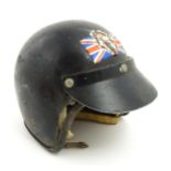 A mid 20thC motorcycle helmet, with black finish and visor. Internal measurement approx. 8 3/4" x