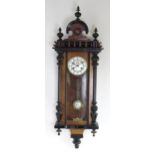 A Continental walnut cased 8-day wall clock, the white enamel dial having ottoman numeral chapter