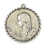 A silver plate pendant of medallion form. Approx. 1 3/4" wide Please Note - we do not make reference