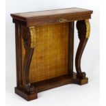 A 19thC pier table / console table with an inset gold tooled leather top and backboard, the top