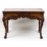 A Victorian mahogany console table with a moulded top above an acanthus carved apron and cabriole