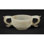 Jade. A Chinese jade two handle wine cup, probably 18th century