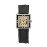 CARTIER: A PLATINUM AND 18CT GOLD DIAMOND AND ONYX SET WRISTWATCH