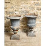 A PAIR OF GREY PAINTED METAL GARDEN URNS