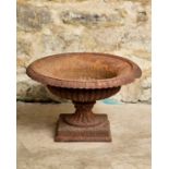 A WEATHERED IRON GARDEN URN