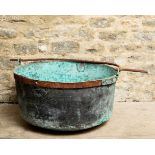 A HUGE RIVETTED COPPER CAULDRON WITH VERDIGRIS PATINATION
