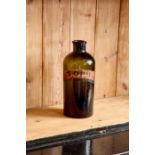 A LARGE OLIVE GLASS APOTHECARY BOTTLE