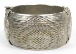 A Middle Eastern white metal slave design bangle, 6.5cm in diameter x 3.5cm deep, 60.9g.