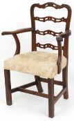 A 19th century mahogany pierced ladder back elbow chair, the overstuffed seat raised on moulded