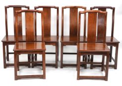 A set of six Chinese hardwood dining chairs, early 20th century, the splat backs above solid