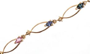 A 10K gold multi gem openwork bracelet set with diamonds, pink spinel and blue spinel, 19cm in