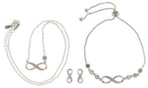 A silver infinity jewellery suite set with clear stones comprising necklace, bracelet and stud
