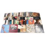 A collection of vinyl LP records including The Doors LA Woman, David Bowie Hunky Dory and Neil Young