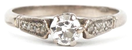 An 18ct white gold diamond solitaire ring with diamond set shoulders, the diamond solitaire
