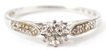 A 9ct white gold diamond solitaire ring with diamond set shoulders, total diamond weight