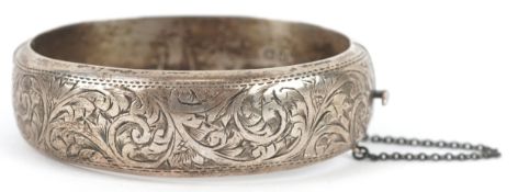 Joseph Smith & Sons, a Victorian style silver bangle with engraved floral decoration, Chester