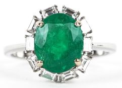 An 18ct white gold emerald and baguette cut diamond cluster ring, total diamond weight 0.41 carat,