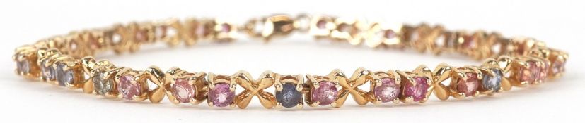A 9ct gold multi gem panel bracelet including ruby and topaz, 19cm in length, 8.8g.